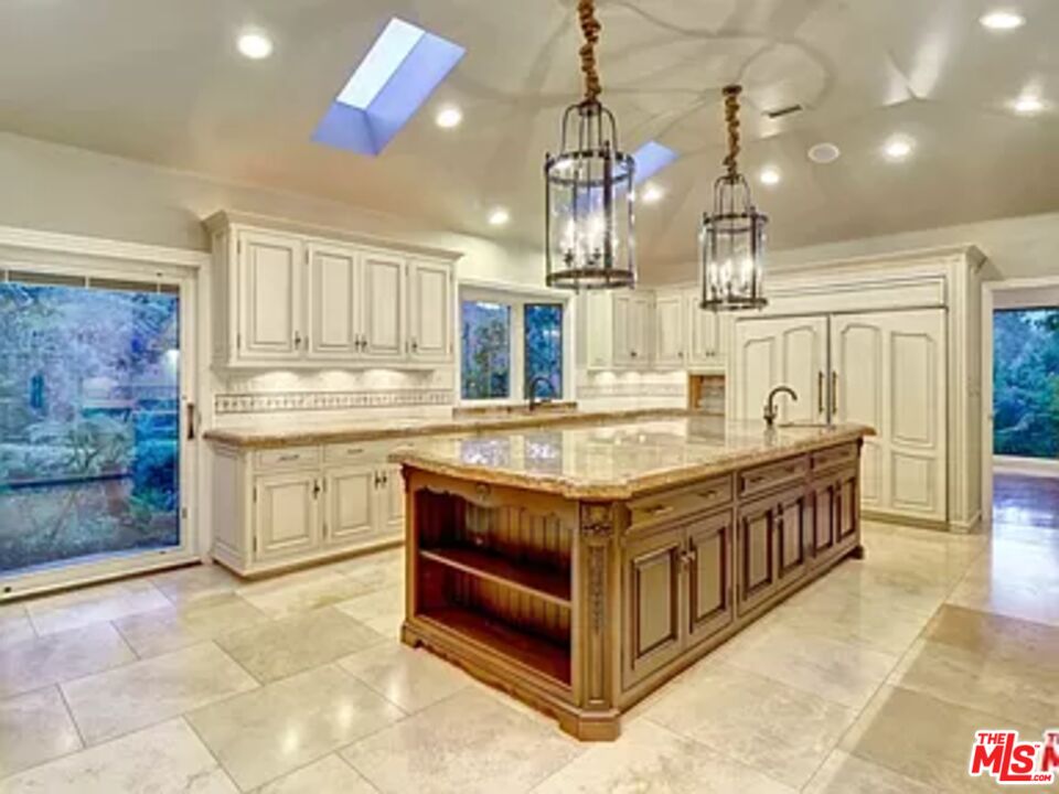 1681 Stone Canyon Road Los Angeles, CA 90077 - Photo 17 of 41 a kitchen with stainless steel appliances granite countertop a stove and a sink