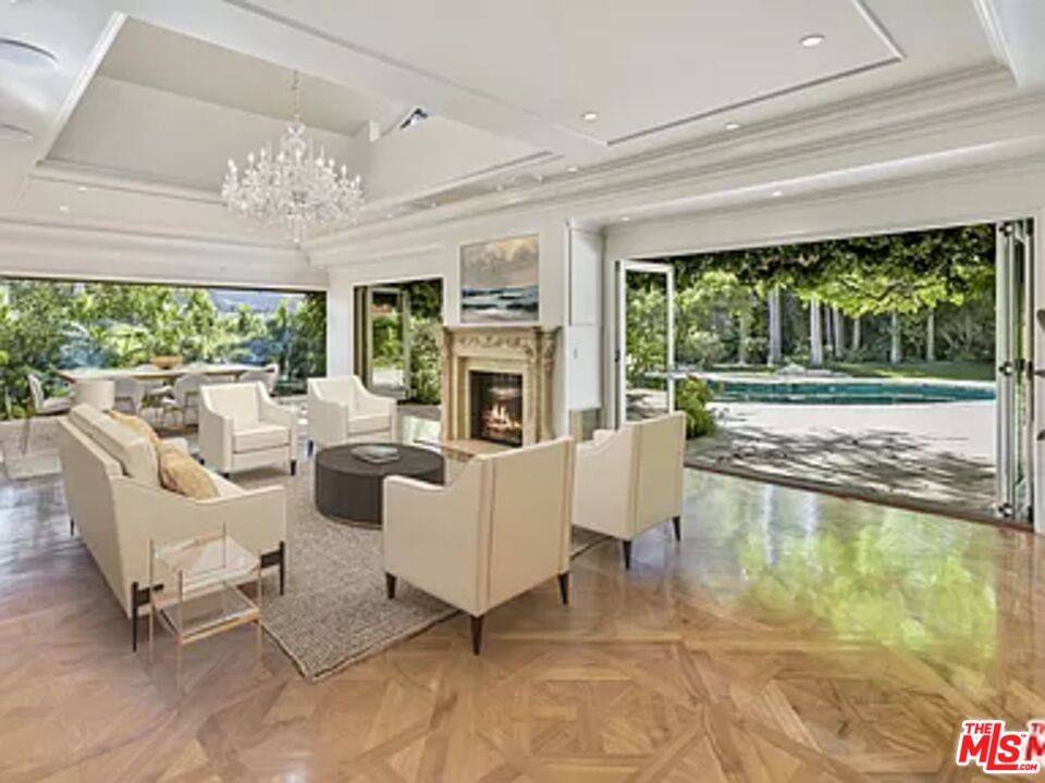 1681 Stone Canyon Road Los Angeles, CA 90077 - Photo 24 of 41 a living room with fireplace furniture and a large window