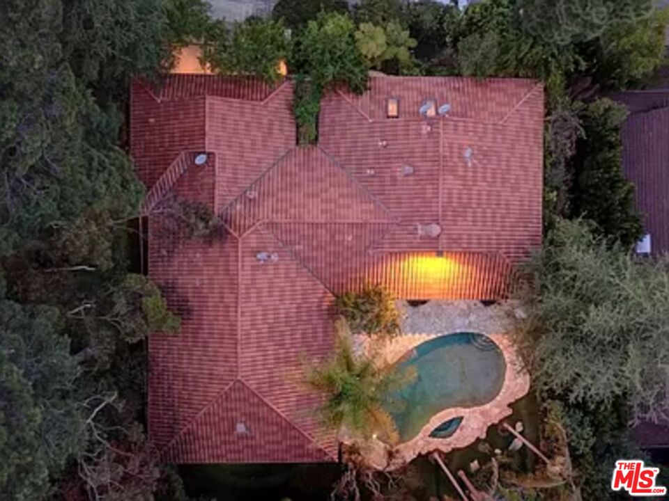 1681 Stone Canyon Road Los Angeles, CA 90077 - Photo 25 of 41 a aerial view of a house with swimming pool and large trees