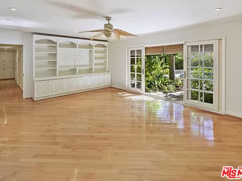 1681 Stone Canyon Road Los Angeles, CA 90077 - Photo 3 of 41 a view of empty room with wooden floor and floor to ceiling window