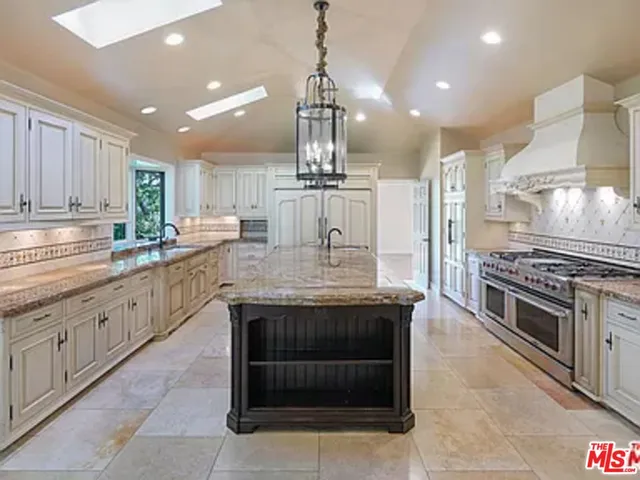 a kitchen with stainless steel appliances granite countertop a stove and cabinets
