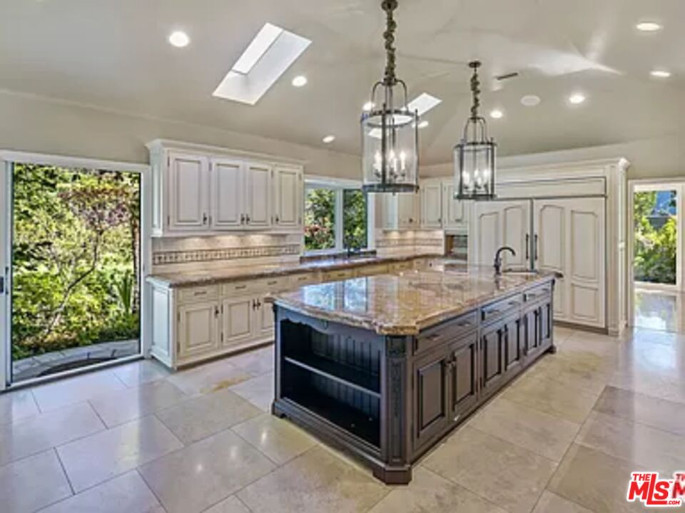 1681 Stone Canyon Road Los Angeles, CA 90077 - Photo 38 of 41 a kitchen with stainless steel appliances granite countertop a stove a sink and a refrigerator