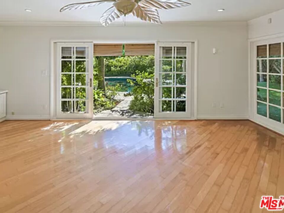 1681 Stone Canyon Road Los Angeles, CA 90077 - Photo 40 of 41 a view of an empty room with a window and wooden floor