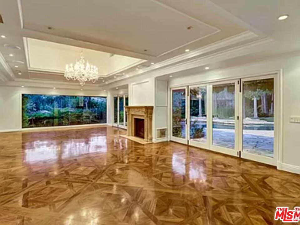 1681 Stone Canyon Road Los Angeles, CA 90077 - Photo 5 of 41 a view of an entryway with floor to ceiling windows and a rug