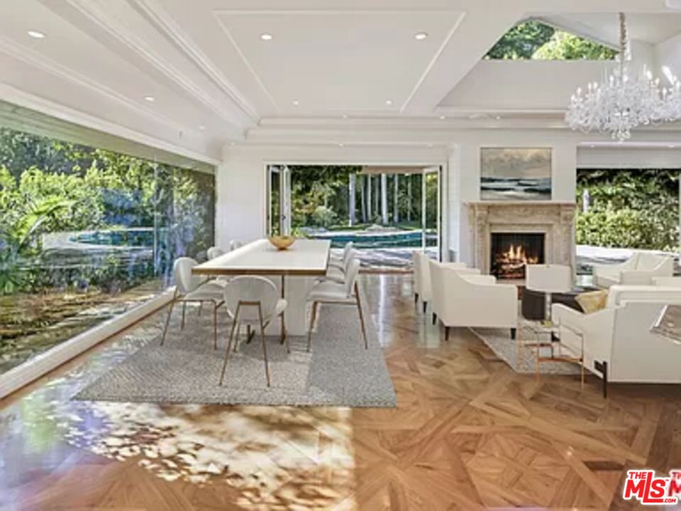1681 Stone Canyon Road Los Angeles, CA 90077 - Photo 10 of 41 a living room with fireplace furniture and a large window