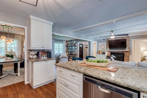 a kitchen with granite countertop a sink and a stove top oven