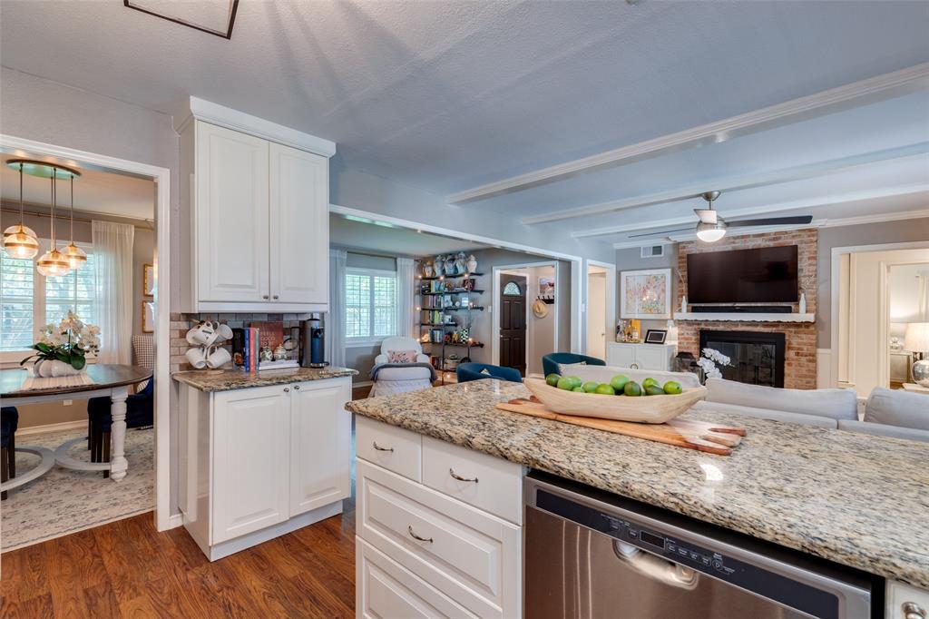 7328 Rockhurst Drive Dallas, TX 75214 - Photo 14 of 22 a kitchen with granite countertop a sink and a stove top oven