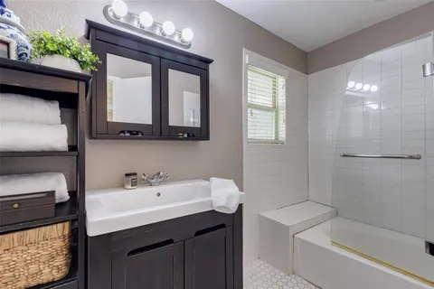 a bathroom with a sink a toilet and bathtub