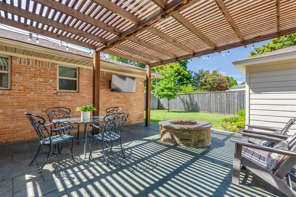 7328 Rockhurst Drive Dallas, TX 75214 - Photo 20 of 22 a view of a patio with couple of chairs and a table