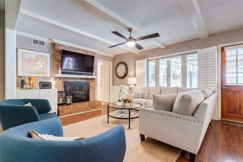 a living room with fireplace furniture and a flat screen tv