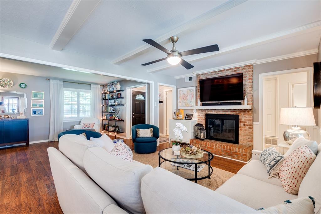 7328 Rockhurst Drive Dallas, TX 75214 - Photo 6 of 22 a living room with furniture a fireplace and a flat screen tv