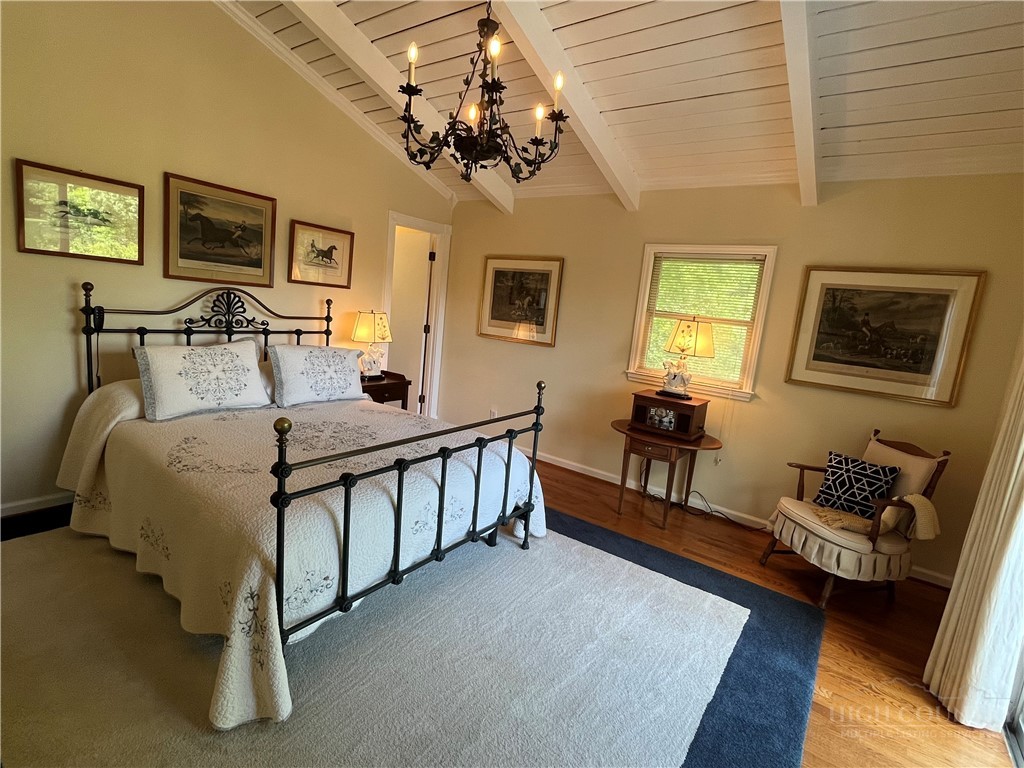 638 Ridge Road Glade Valley, NC 28627 - Photo 19 of 44 a spacious bedroom with a bed and a couch
