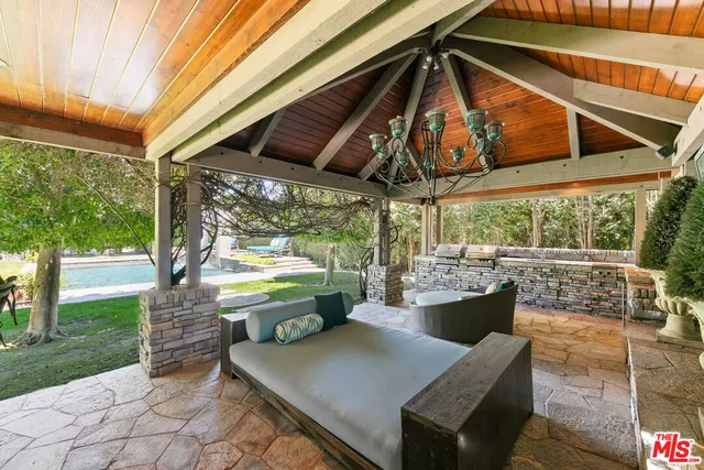a view of a house with backyard porch and sitting area