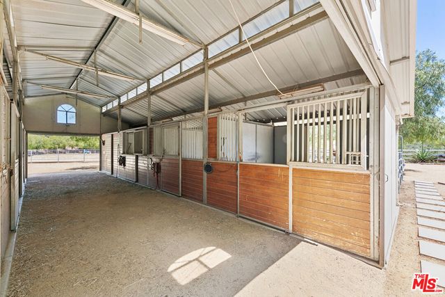 a view of a hallway to a livingroom with furniture