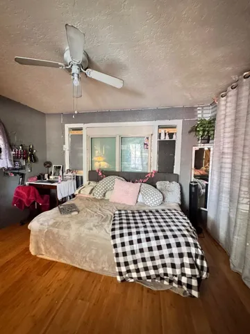 a bedroom with a bed and dresser with mirror
