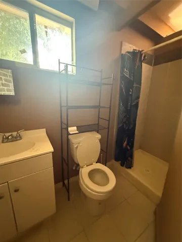 a view of a balcony with a bench and a potted plant