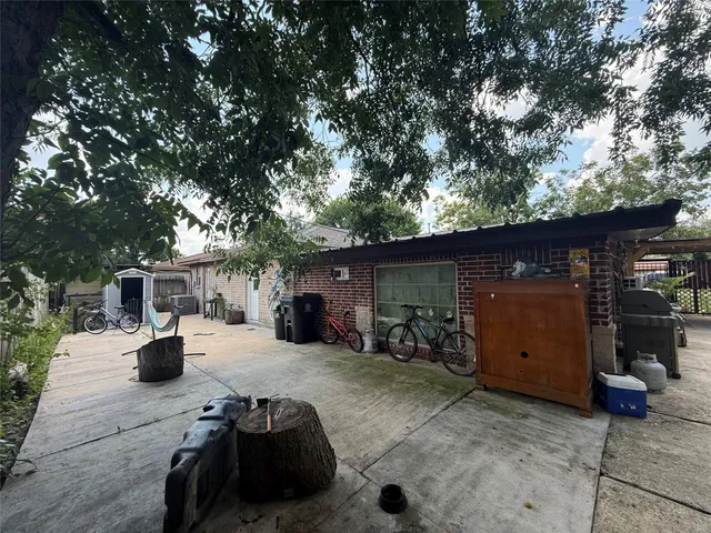 a view of backyard with outdoor seating and car parked