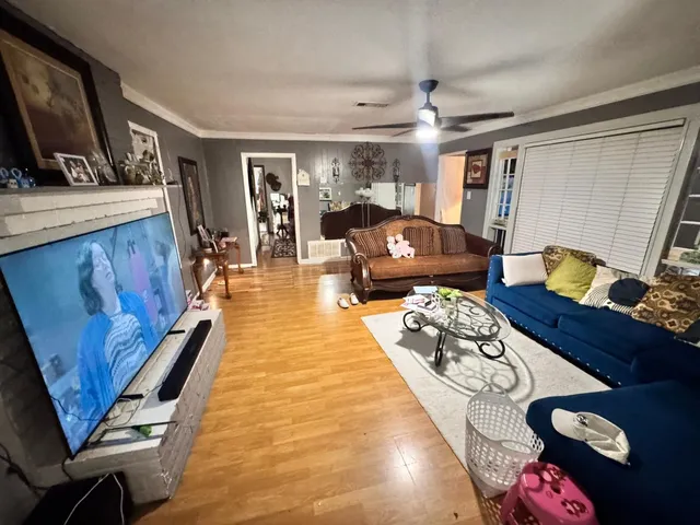 a bedroom with furniture and a flat screen tv