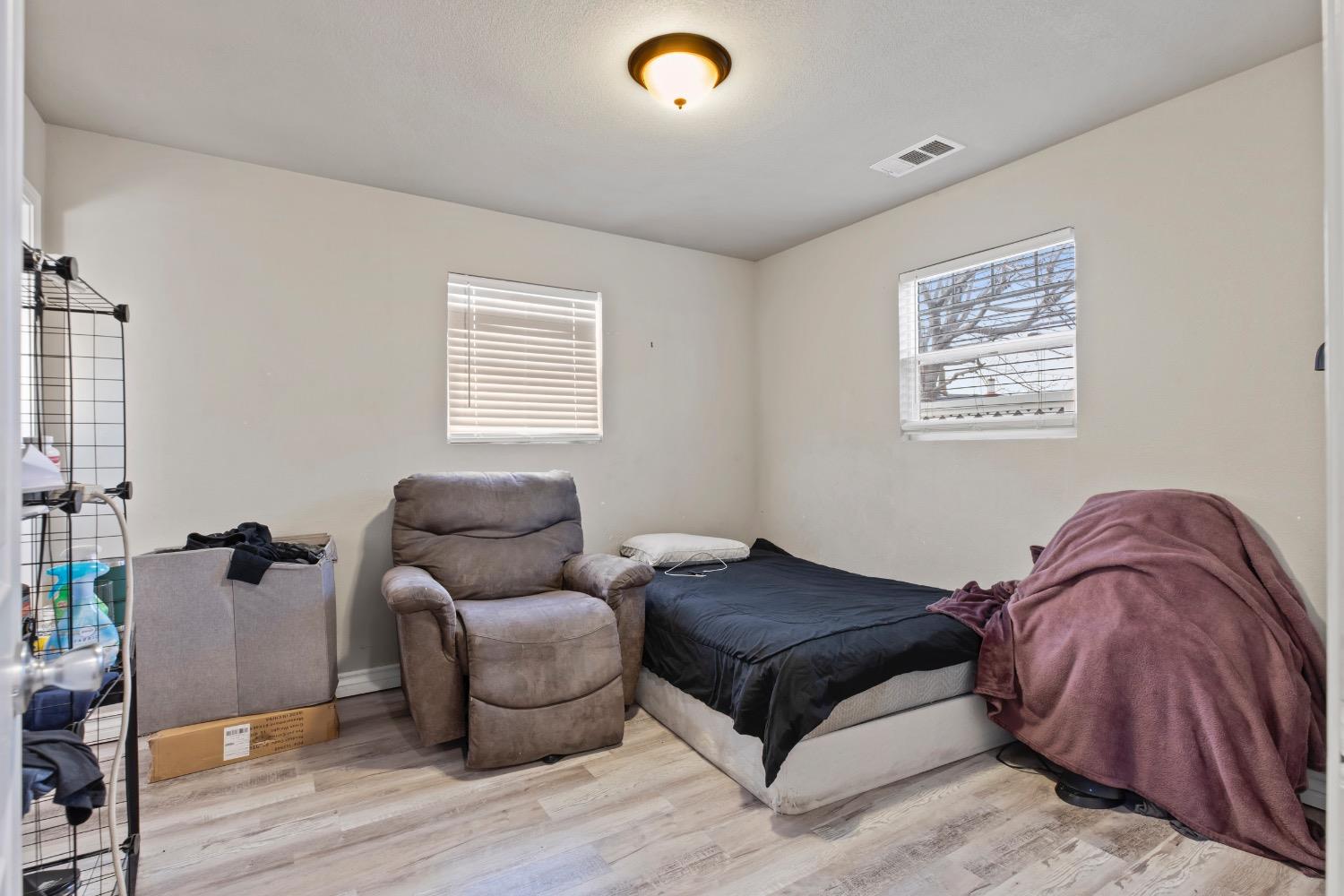 1813 Poppy Lane Ceres, CA 95307 - Photo 16 of 27 a bedroom with a bed and window