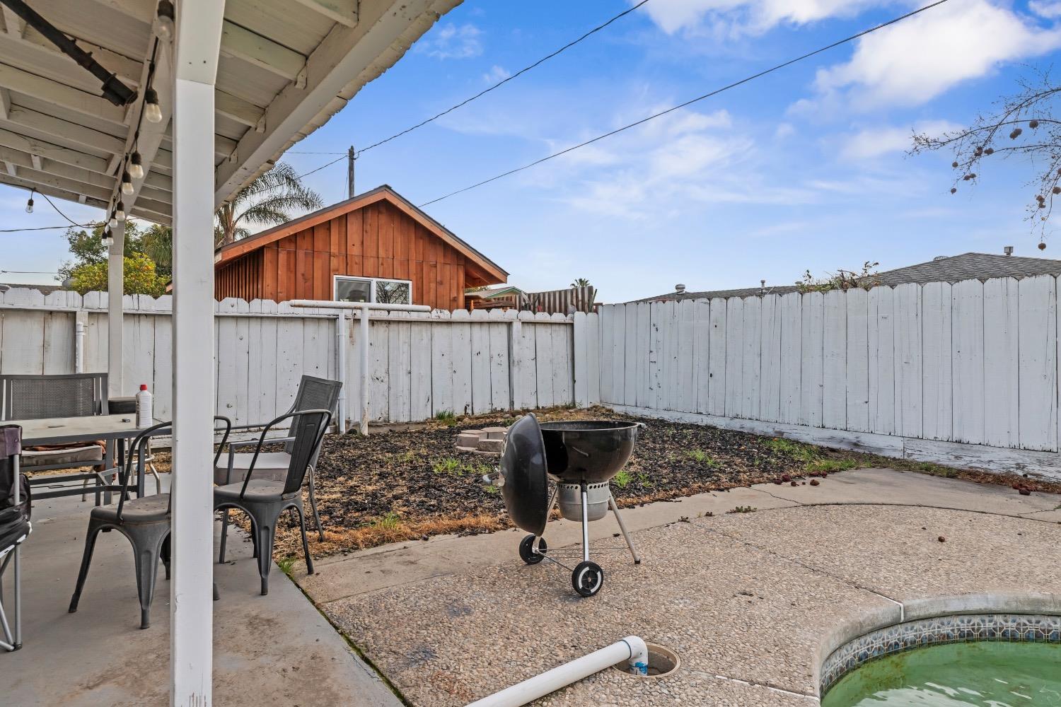 1813 Poppy Lane Ceres, CA 95307 - Photo 20 of 27 a backyard of a house with table and chairs