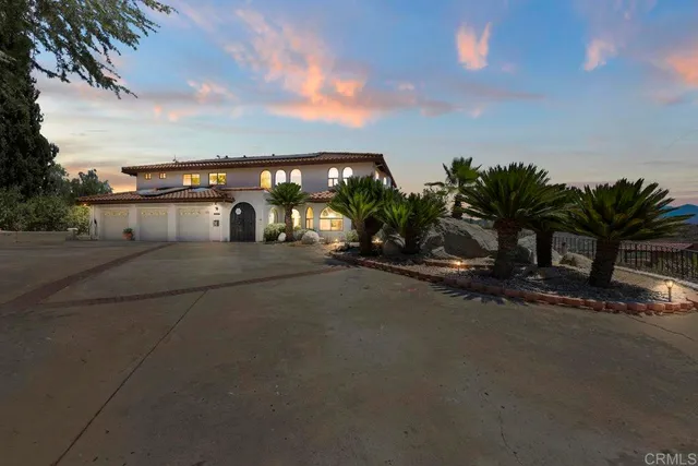 a view of a street with palm trees