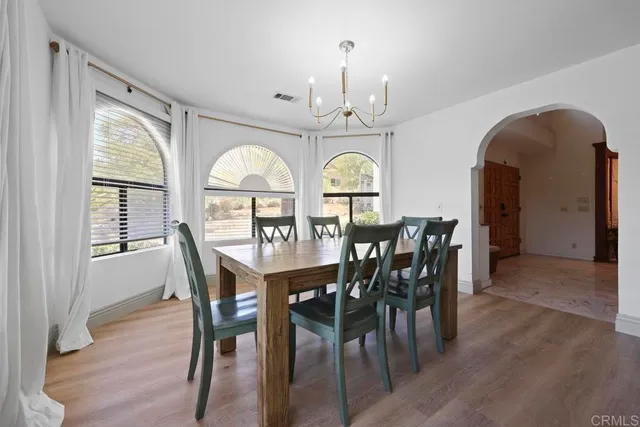 a kitchen with stainless steel appliances kitchen island granite countertop a refrigerator and cabinets