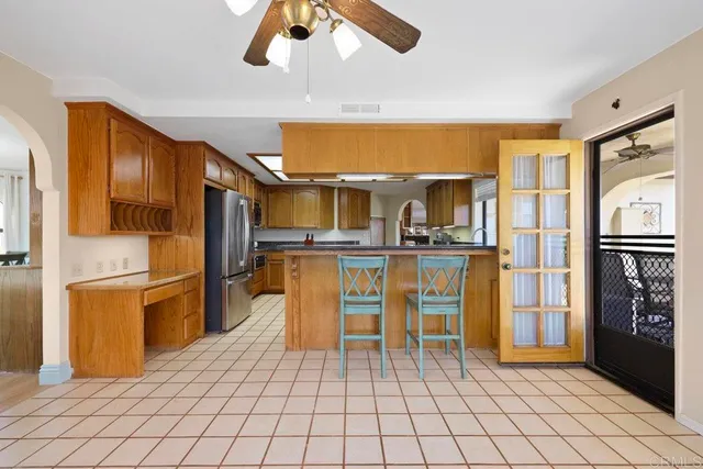 a kitchen with stainless steel appliances granite countertop sink stove top oven and cabinets