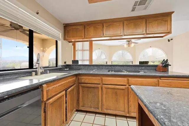 a kitchen with stainless steel appliances granite countertop a stove a sink and dishwasher
