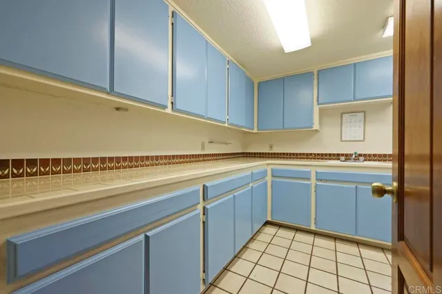 a view of a livingroom with workspace and a window