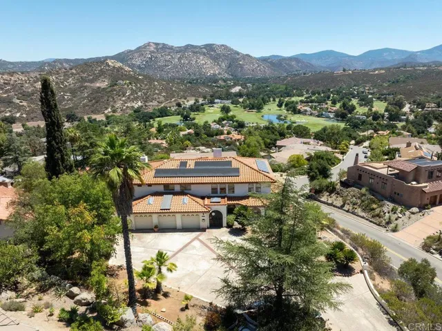 an aerial view of residential house and sandy dunes