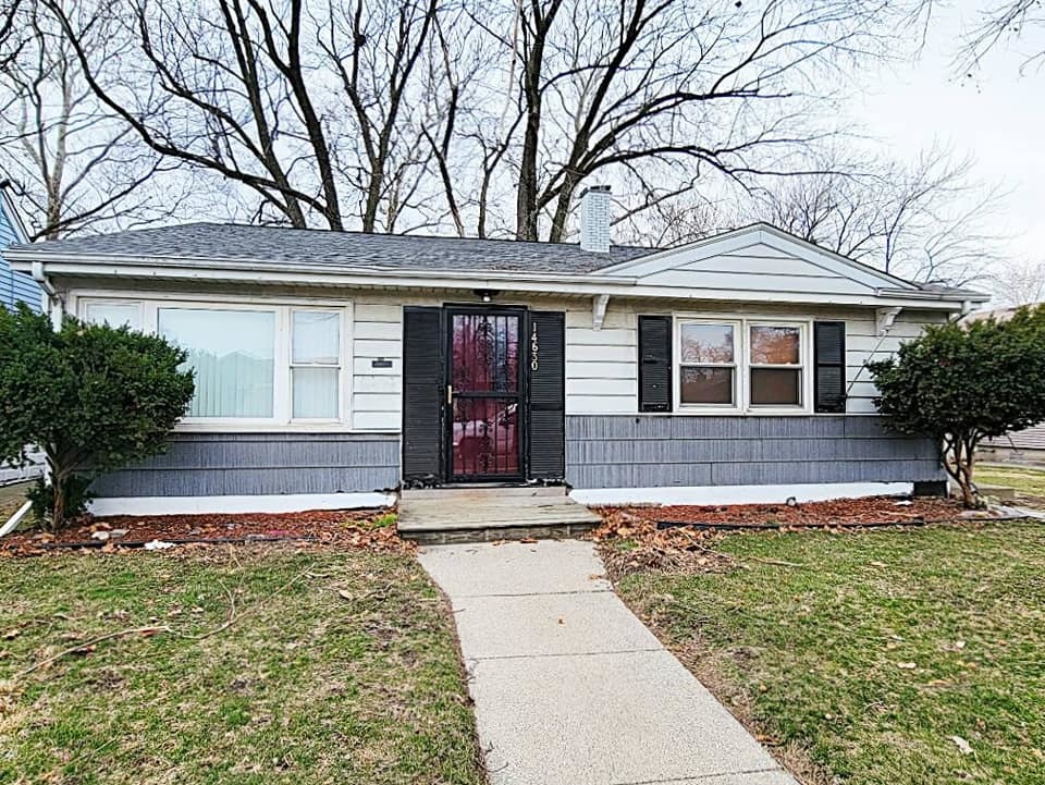 Undisclosed Address Dolton, IL 60419 - Photo 1 of 9 front view of a house with a yard