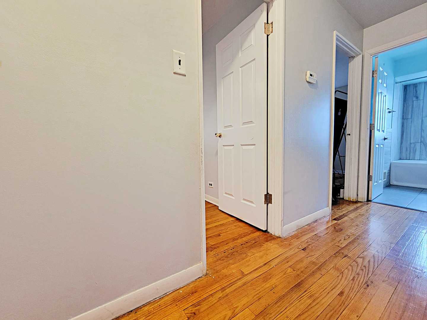 Undisclosed Address Dolton, IL 60419 - Photo 5 of 9 a view of a hallway with wooden floor