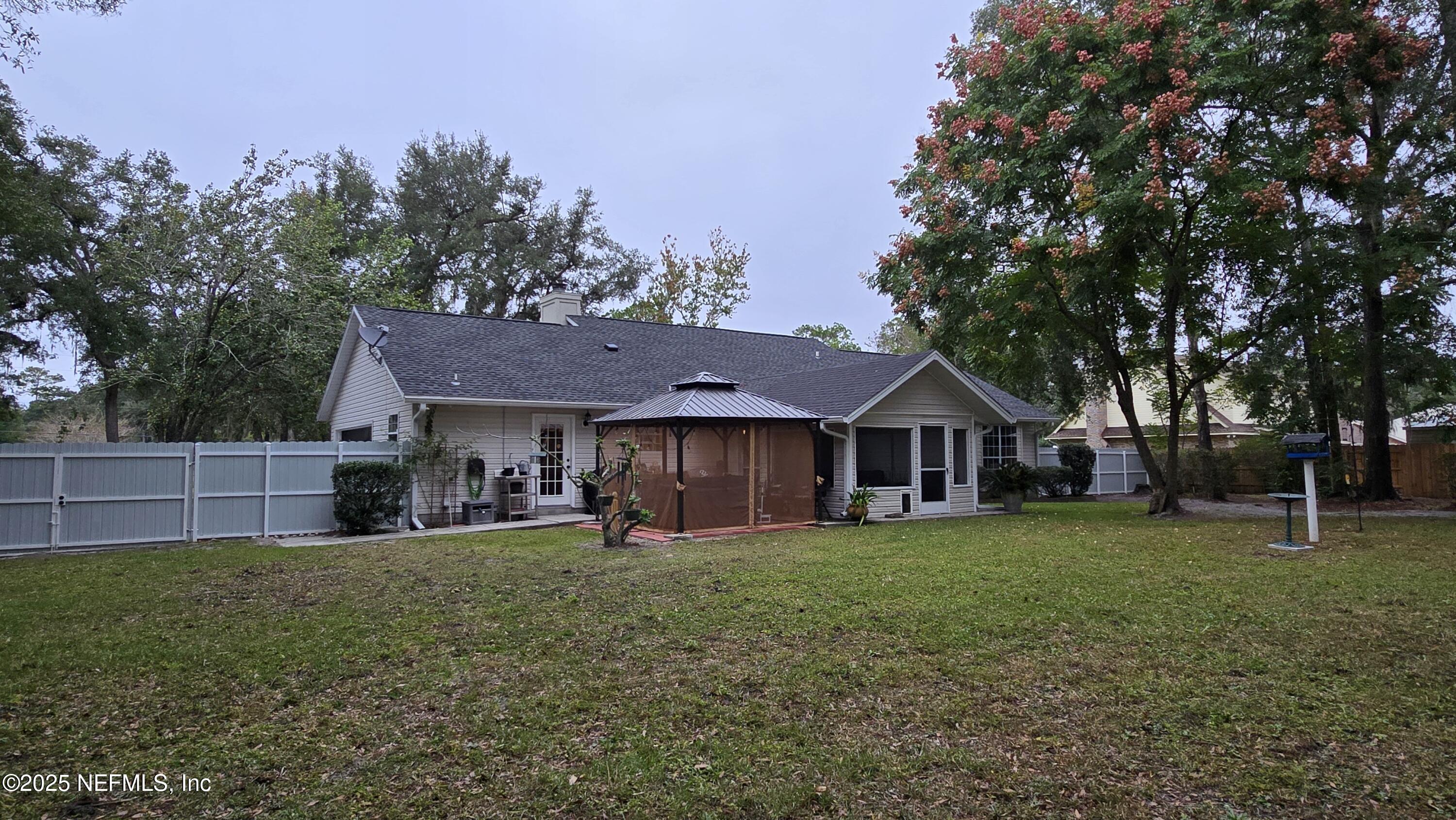 12984 92nd Street Live Oak, FL 32060 - Photo 30 of 32 a view of a house with a big yard and large trees