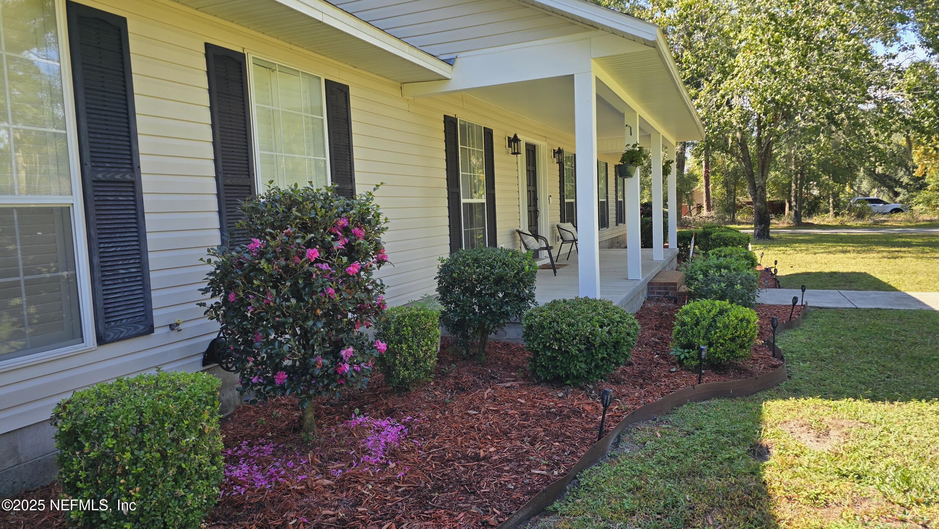 12984 92nd Street Live Oak, FL 32060 - Photo 4 of 32 a front view of a house with garden