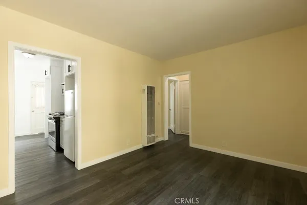 a view of a room with wooden floor