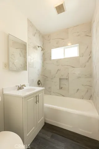 a bathroom with a sink a toilet and bathtub