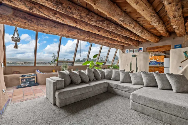 a living room with furniture a large window with outer view