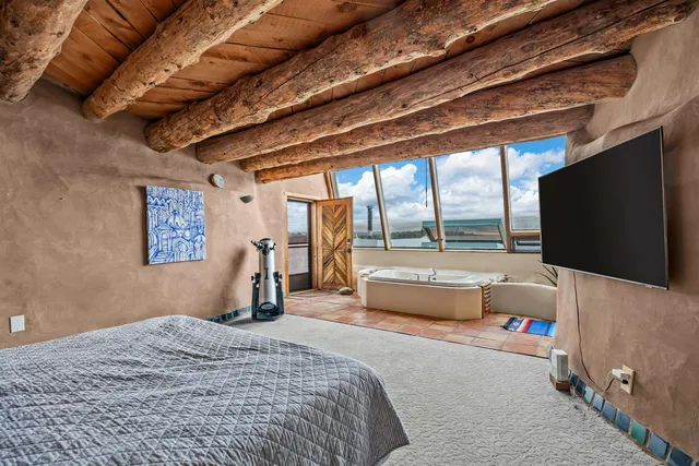 a bedroom with furniture and a flat screen tv