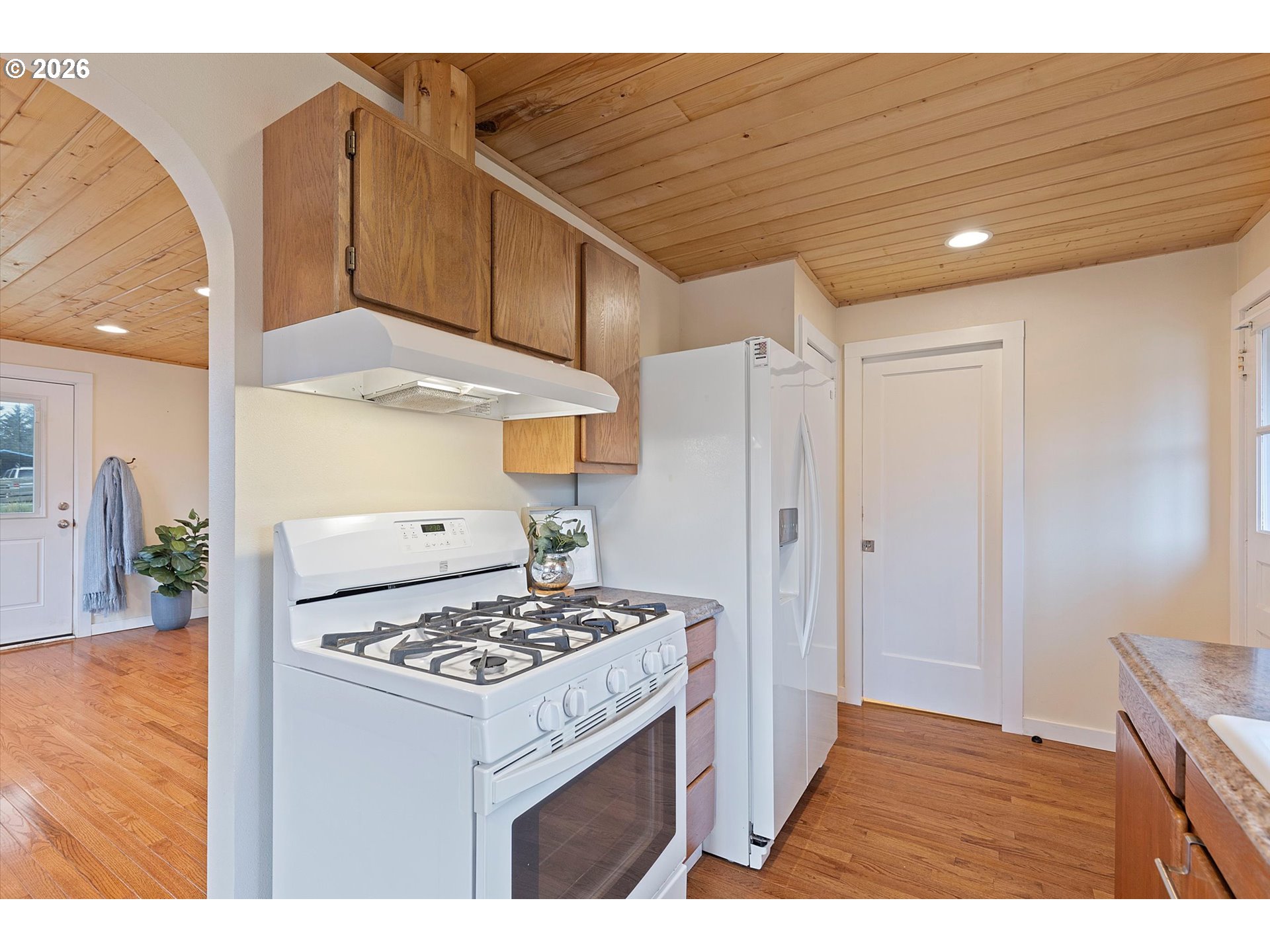 5093 Northeast 49th Street Neotsu, OR 97364 - Photo 11 of 36 a kitchen that has a lot of cabinets a stove and a refrigerator