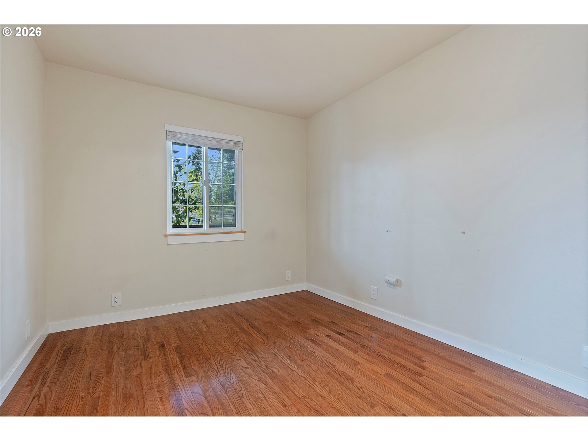 5093 Northeast 49th Street Neotsu, OR 97364 - Photo 13 of 36 a view of an empty room with wooden floor and a window