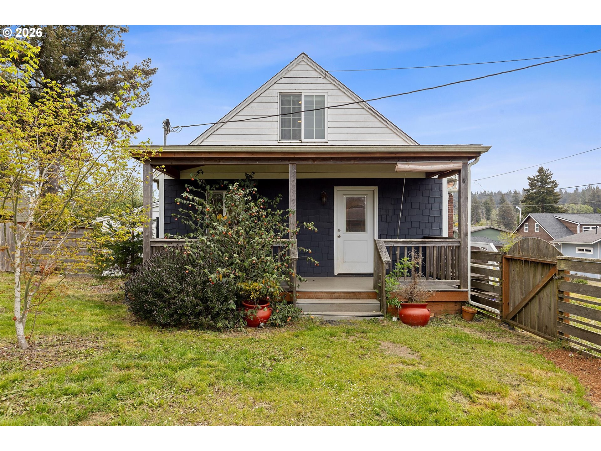 5093 Northeast 49th Street Neotsu, OR 97364 - Photo 22 of 36 a front view of a house with swing and plants