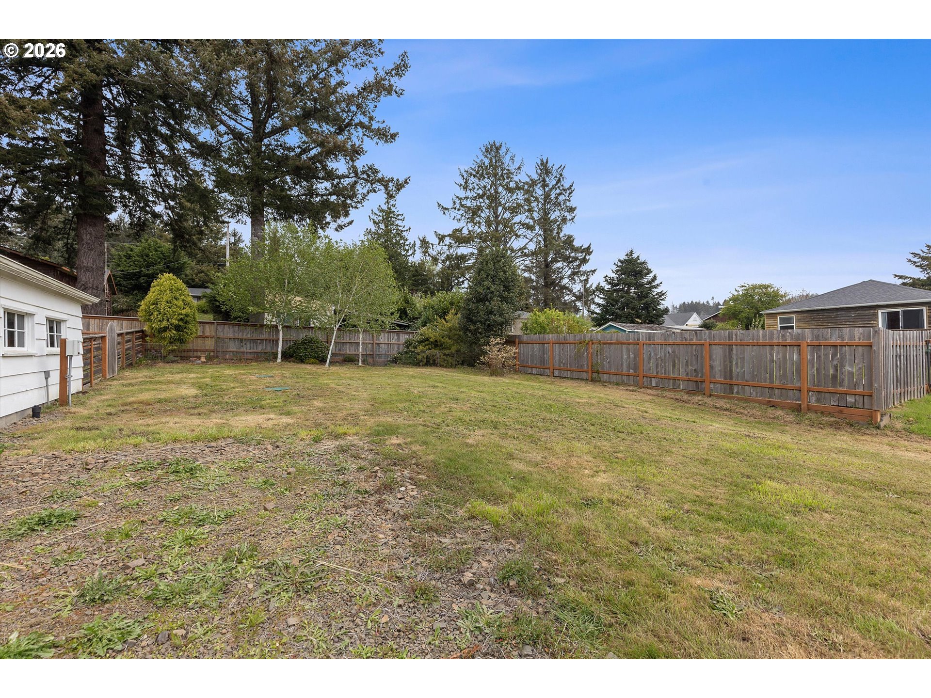 5093 Northeast 49th Street Neotsu, OR 97364 - Photo 31 of 36 a view of a backyard with large trees