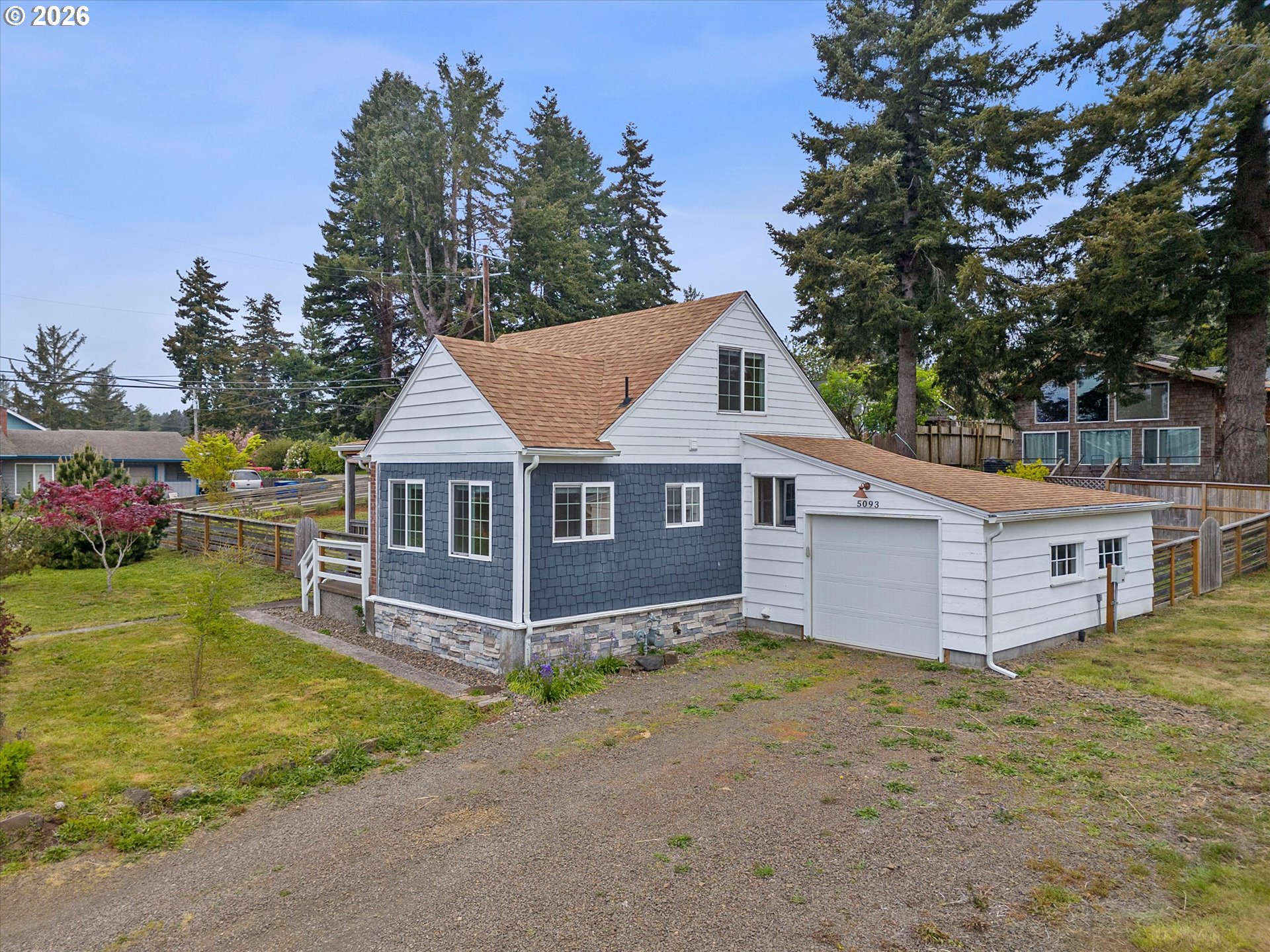 5093 Northeast 49th Street Neotsu, OR 97364 - Photo 5 of 36 a view of a house with a yard and large tree