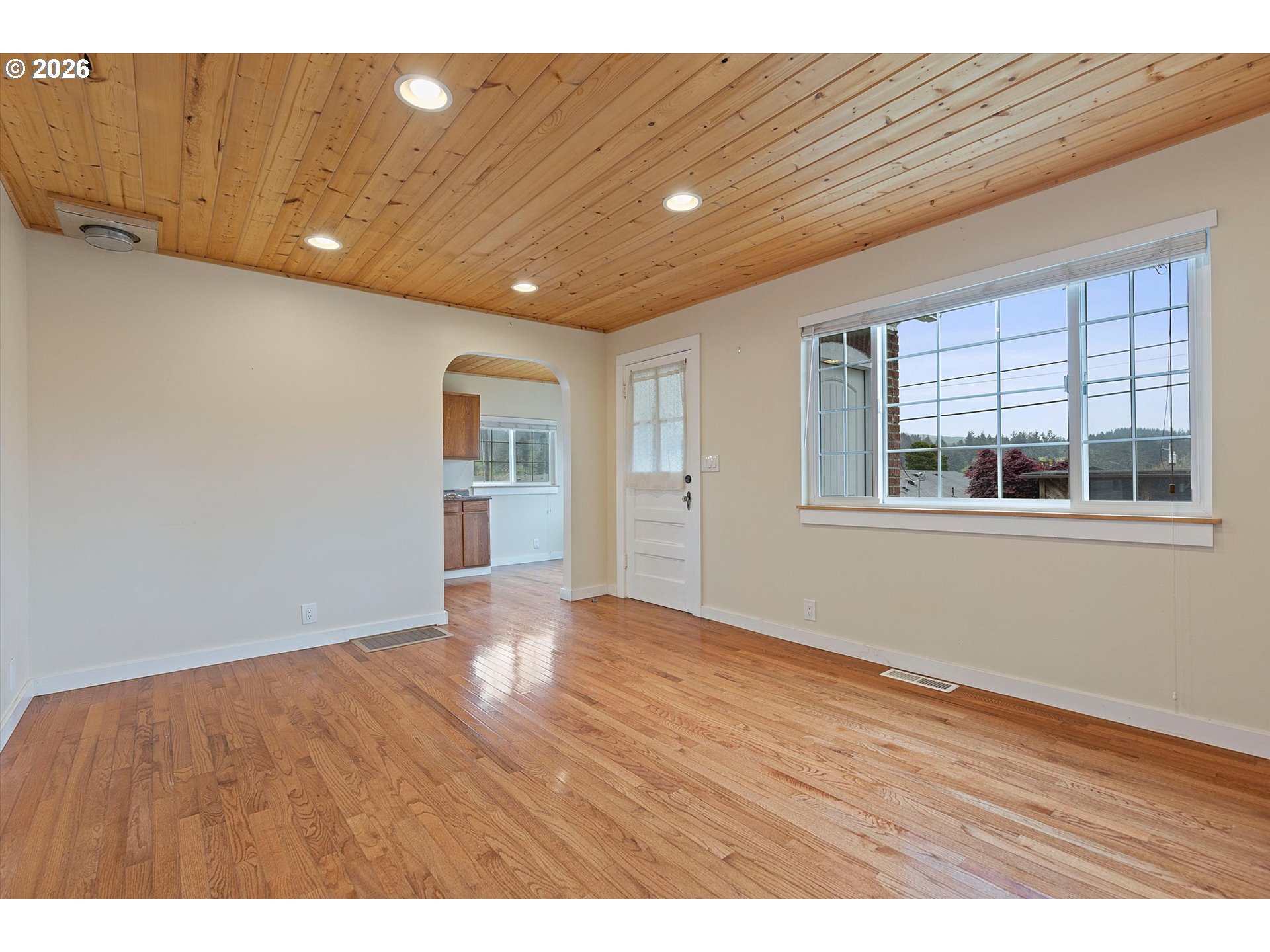 5093 Northeast 49th Street Neotsu, OR 97364 - Photo 7 of 36 a view of empty room with wooden floor and fan