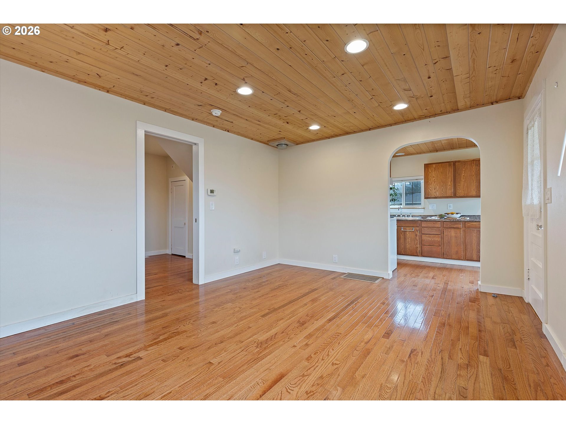 5093 Northeast 49th Street Neotsu, OR 97364 - Photo 9 of 36 a view of an empty room with wooden floor and a window