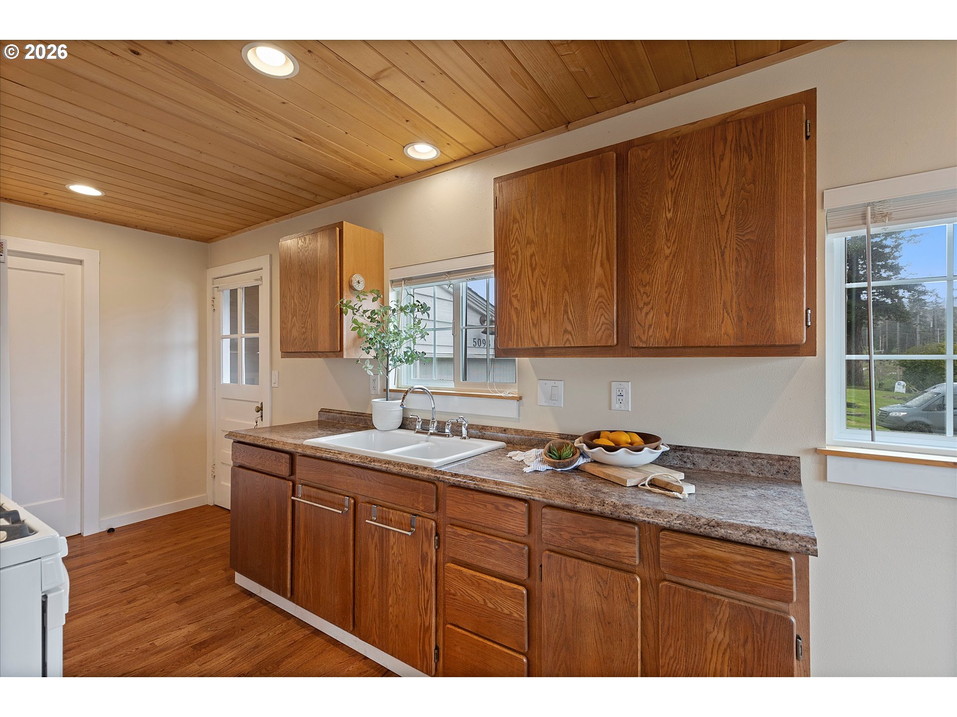 5093 Northeast 49th Street Neotsu, OR 97364 - Photo 10 of 36 a kitchen that has a sink and cabinets