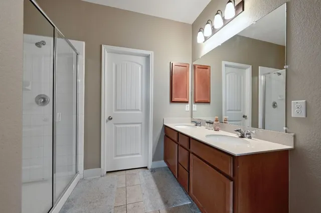 a bathroom with a double vanity sink and mirror