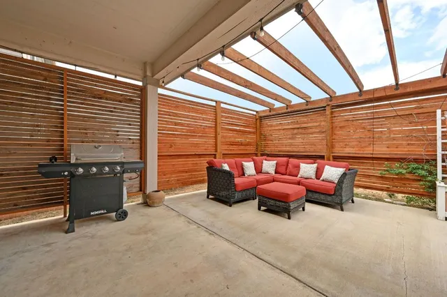 a living room with furniture a front door and wooden floor