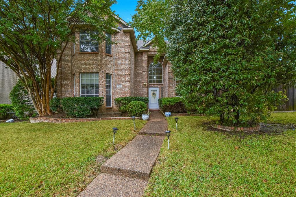 3113 Riverside Drive Carrollton, TX 75007 - Photo 1 of 1 a front view of a house with garden