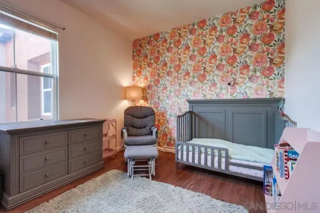 a bedroom with a bed chair and a window